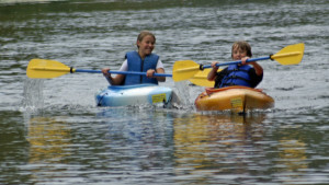 Kids loving kayaking river