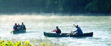 Mist on the river and canoes