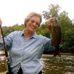 Lady with small mouth bass fish